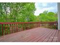 Spacious wooden deck overlooking lush greenery, perfect for outdoor relaxation at 10805 Winterbourne Ct, Charlotte, NC 28277