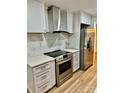 Modern kitchen features stainless steel appliances, updated cabinetry, and stylish marble backsplash at 10805 Winterbourne Ct, Charlotte, NC 28277