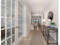 Light-filled foyer with hardwood floors, decorative trim, and French doors leading to another room at 109 Crossvine Dr, Mooresville, NC 28117