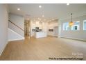 Spacious open floor plan featuring a staircase and a seamless transition to the all-white kitchen at 1107 Meander Ln, Waxhaw, NC 28173