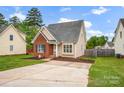 Attractive home featuring a brick and siding design, a well-kept lawn, and a paved driveway at 126 Newsome Rd, Salisbury, NC 28146