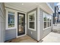 Close-up of the townhome entrance with glass door, windows, and gray siding at 134 Berkeley Ave, Mooresville, NC 28117