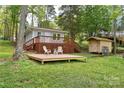 Inviting backyard featuring a deck with seating and a shed at 139 Sanford Ln, Badin Lake, NC 28127