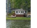 Charming home with lake views and a deck with chairs perfect for relaxing at 139 Sanford Ln, Badin Lake, NC 28127