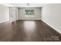 Open floor plan showcasing the spacious living room with wood-look flooring at 1399 Foxbrook Cir, Lancaster, SC 29720