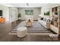 Bright, inviting living room with a striped rug, white couch and modern decor at 1399 Foxbrook Cir, Lancaster, SC 29720