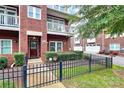 Charming brick townhome showcasing a private entrance, well-maintained landscaping, and a welcoming walkway at 1412 W 4Th St, Charlotte, NC 28208