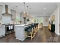 Modern kitchen with stainless steel appliances, gray cabinets, pendant lighting, and large island with bar seating at 1412 W 4Th St, Charlotte, NC 28208