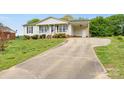Attractive ranch-style home with a covered carport, landscaped front yard, and an extended driveway at 1504 Andicot Ln, Shelby, NC 28152