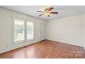 Bright living room featuring hardwood floors, a ceiling fan, and a large window at 1504 Andicot Ln, Shelby, NC 28152