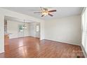 Open living area with hardwood floors, white walls, and access to the kitchen at 1504 Andicot Ln, Shelby, NC 28152