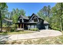 Charming home with a large driveway and attached garage, nestled in a serene, wooded setting at 16518 Here At Last Ln, Charlotte, NC 28278