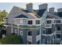 Low angle of a building's exterior, showing the decks and beautiful architecture at 18723 Vineyard Point Ln, Cornelius, NC 28031