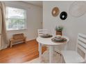 Cozy dining area with hardwood floors and a white round table for intimate meals at 216 Wakefield Dr # B, Charlotte, NC 28209
