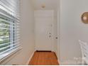 Bright entryway featuring hardwood floors and natural light from the window at 216 Wakefield Dr # B, Charlotte, NC 28209