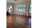 Bright living room featuring hardwood floors, a fireplace, and plentiful natural light at 240 North Ave, Troutman, NC 28166