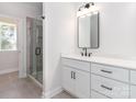 Contemporary bathroom featuring a glass-enclosed shower, white vanity, and tile flooring at 2505 Elon St, Charlotte, NC 28208