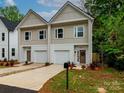 Charming new construction townhomes with neutral siding, white trim, and attached garages in a desirable neighborhood at 2507 Elon St, Charlotte, NC 28208