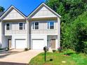 Modern townhome showcasing a well-maintained lawn, twin garages and neutral-toned siding at 2507 Elon St, Charlotte, NC 28208