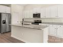 Modern kitchen featuring white cabinets, granite countertops, stainless steel appliances, and a stylish island at 3338 Strong Box Ln, Gastonia, NC 28052