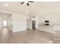 Spacious open-concept living area with light wood floors, vaulted ceilings, and a modern kitchen at 3338 Strong Box Ln, Gastonia, NC 28052