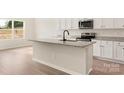 Kitchen island with granite countertops and stainless steel appliances at 3346 Strong Box Ln, Gastonia, NC 28052