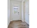 Bright foyer featuring wood-look flooring and a stylish front door with a window at 3813 Amalia Pl, Indian Land, SC 29707