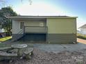 A backyard featuring a concrete patio area with a stone picnic table at 415 S Broad St, Gastonia, NC 28052