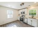 Well-lit kitchen with stainless steel appliances, white cabinets, and sleek countertops, offering a modern and functional space at 4336 Valeview Ln, Charlotte, NC 28269