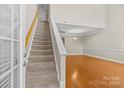 Bright living area showcasing high ceilings, hardwood floors, and staircase at 4418 Coventry Row Ct, Charlotte, NC 28270