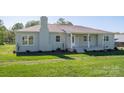 Charming home exterior featuring a brick facade, covered front porch, and well-maintained landscaping at 4979 Plateau Rd, Vale, NC 28168