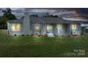 Inviting home exterior featuring a brick facade, covered front porch, and well-maintained landscaping at 4979 Plateau Rd, Vale, NC 28168