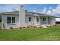 A lovely ranch-style home with a white brick exterior and an inviting front porch at 4979 Plateau Rd, Vale, NC 28168