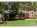 Lovely brick home with lush green lawn and mature trees showcasing curb appeal at 4989 Post Oak Ln, Rock Hill, SC 29732