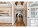 Inviting hallway showcasing wood floors, detailed trim, and an open view to the living room with a fireplace at 5380 Pembrey Dr # Lot 26, Denver, NC 28037