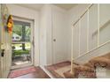 Bright entryway with hardwood floors, and view of the home's staircase at 5623 Eastbrook Rd, Charlotte, NC 28215