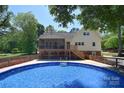 Inviting backyard pool and deck area with a screened porch perfect for outdoor entertaining at 6008 Corkstone Dr, Mint Hill, NC 28227