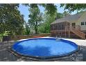 Sparkling pool surrounded by a spacious deck area, perfect for relaxing and enjoying the outdoors at 6008 Corkstone Dr, Mint Hill, NC 28227