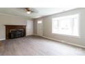 Bright, spacious living room featuring a charming fireplace and large window for natural light at 606 W 19Th Ave, Gastonia, NC 28052