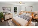 Cozy bedroom with neutral walls, ceiling fan, stylish furnishings, and natural light at 704 Georgie St, Troutman, NC 28166