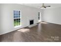 Bright living room featuring a fireplace, recessed lighting and beautiful wood flooring at 704 Georgie St, Troutman, NC 28166