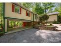 Home featuring an open carport and well-maintained landscaping at 7230 Ridge Lane Rd, Charlotte, NC 28262