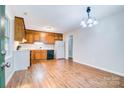 Kitchen featuring wood cabinets, white appliances, and a black dishwasher, all well-lit and functional at 817 32Nd Street Ne Dr, Conover, NC 28613