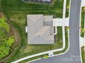 An aerial view of a house with a large yard, driveway, and sidewalk; a beautiful neighborhood surrounds it at 8903 Ansley Park Pl, Huntersville, NC 28078