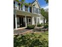 Charming home with a cozy front porch and lush landscaping at 9003 Brad Ct, Matthews, NC 28104