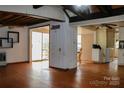 Spacious living room featuring hardwood floors and a sliding door to outside deck at 9216 Caycee Dr # 32, Davidson, NC 28036