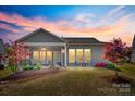 A covered patio overlooks the lush backyard, providing an ideal space for relaxation and entertainment at 953 Kirby Dr, Fort Mill, SC 29715