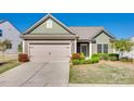 Inviting single-story home with a manicured front lawn and an attached two-car garage at 953 Kirby Dr, Fort Mill, SC 29715