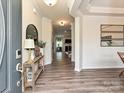 Inviting foyer featuring hardwood floors, elegant decor, and an open view into the living spaces at 10035 Mast Cove Ln, Charlotte, NC 28278