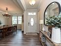 Bright foyer featuring hardwood floors, a stylish mirror, and a glimpse of the dining area at 10035 Mast Cove Ln, Charlotte, NC 28278